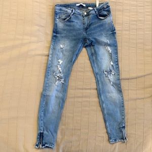 Zara skinny destroyed denim jeans with ankle zippers.